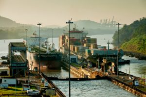 Cargo ships at the entrance of Miraflores Locks. Panama Canal, Panama City, Panama, Central America.