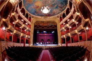 vista del teatro nacional de ciudad de panamá con gente ensayando en el escenadrio